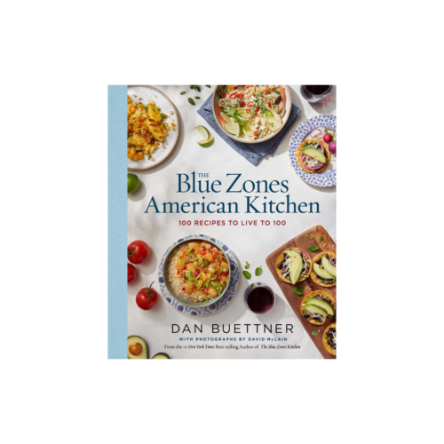 White Blue Zones American Kitchen book that features 100 recipes to live to 100. The cover of the book has several dishes (tacos, rice bowls, salads with tomatoes, avocados and lime wedges throughout)
