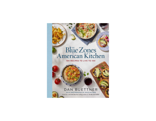 White Blue Zones American Kitchen book that features 100 recipes to live to 100. The cover of the book has several dishes (tacos, rice bowls, salads with tomatoes, avocados and lime wedges throughout)