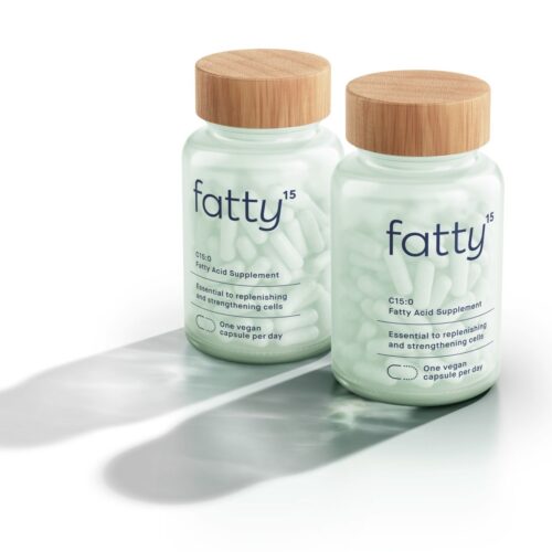 Glass Fatty15 Supplement bottles with a wood top affixed on a white background