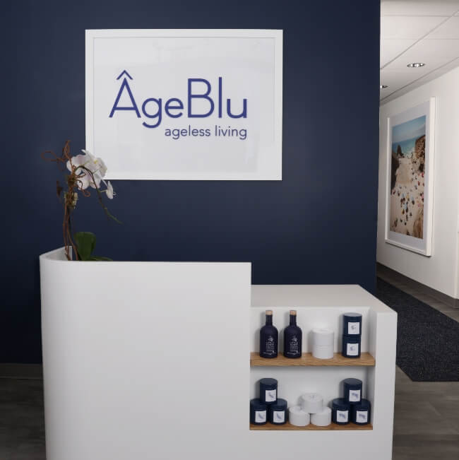 Ageblu sign on a blue wall behind the retail desk