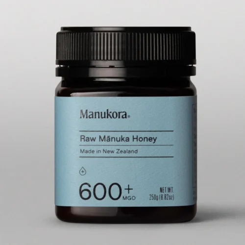 Manukora 600mgo honey in a black bottle with a blue label