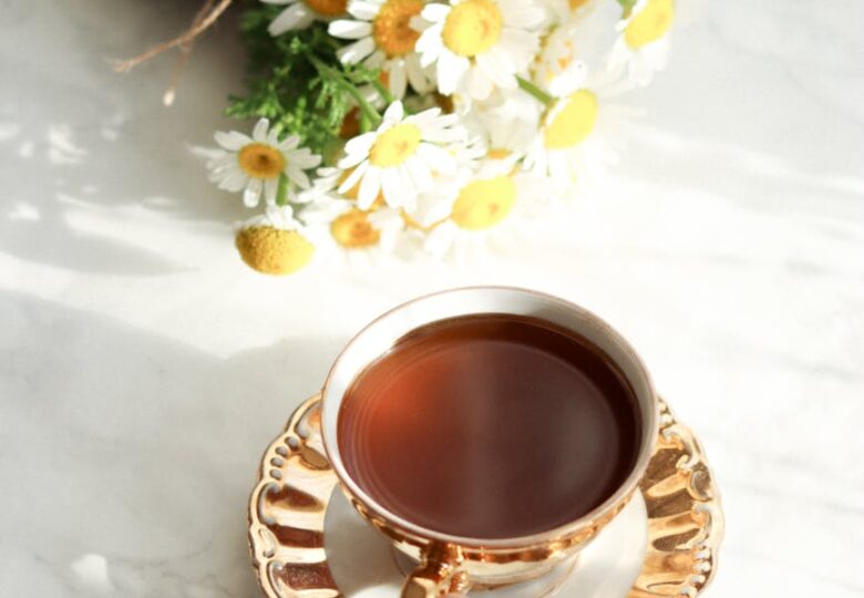 cup of tea and bouquet of daisies