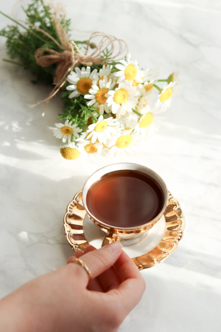 cup of tea and bouquet of daisies