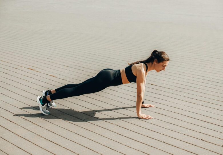 a woman in activewear doing a push up