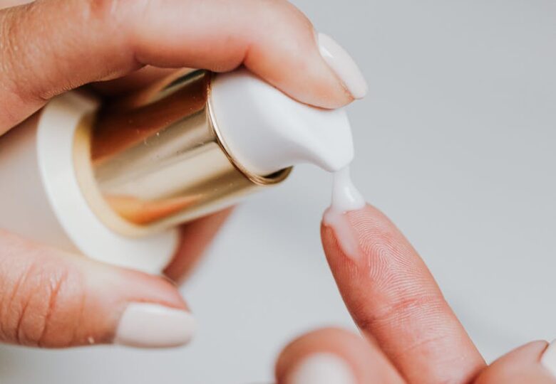 person holding white plastic bottle