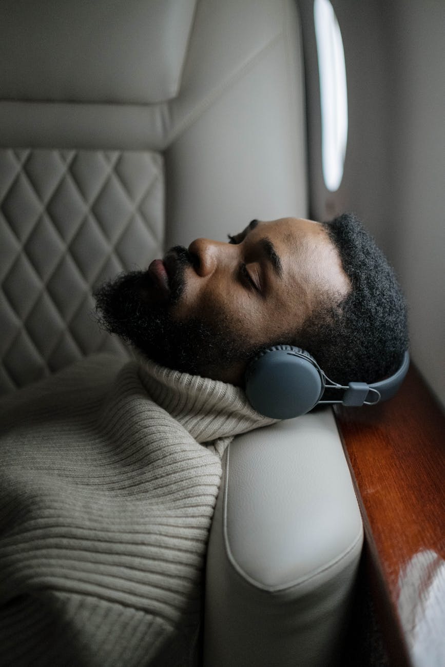 man in gray sweater wearing white headphones